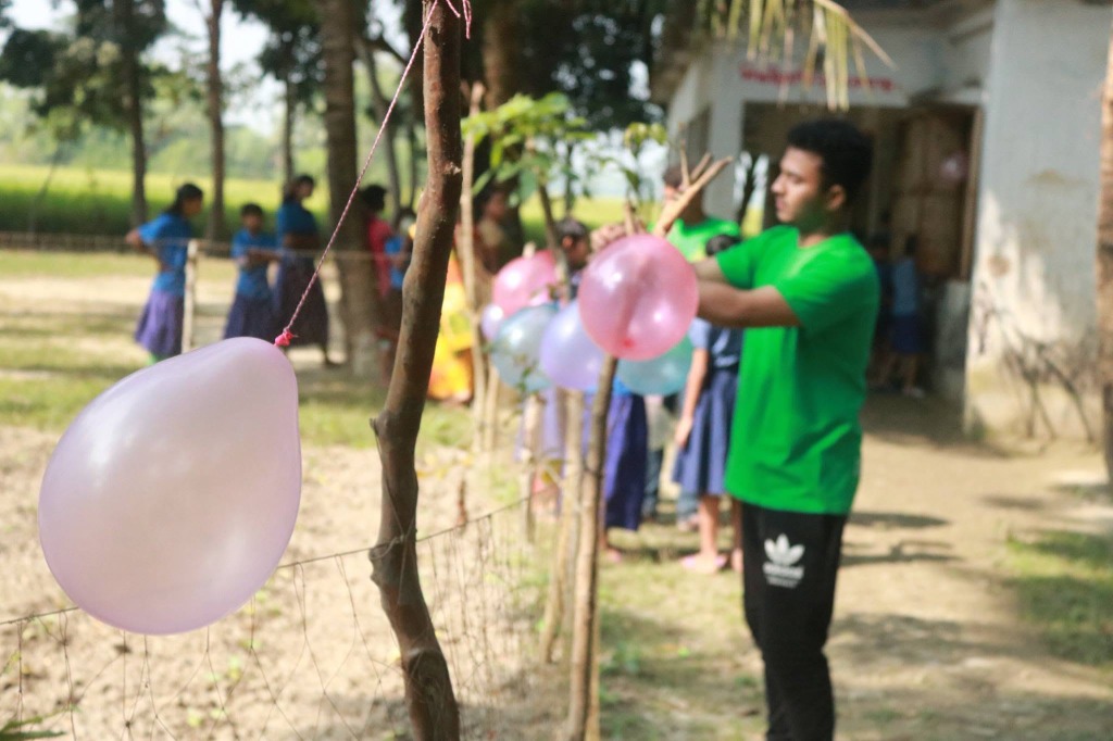 Volunteer Tying Balloons Outside