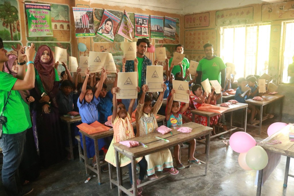 Children Raising Notebook Folders